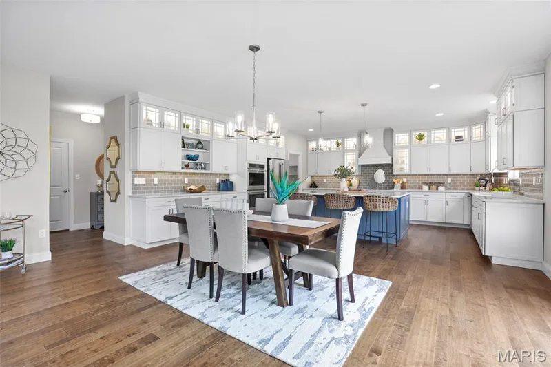 Dining area with a chandelier, dark wood-style flooring, and recessed lighting — 2 Pin Oak at Hawk Ridge Estate, Lake St. Louis, MO 63367