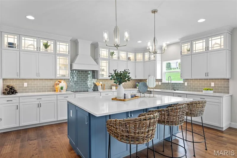 Kitchen featuring blue cabinets, decorative backsplash, white cabinetry, dark wood-style flooring, and recessed lighting — 2 Pin Oak at Hawk Ridge Estate, Lake St. Louis, MO 63367