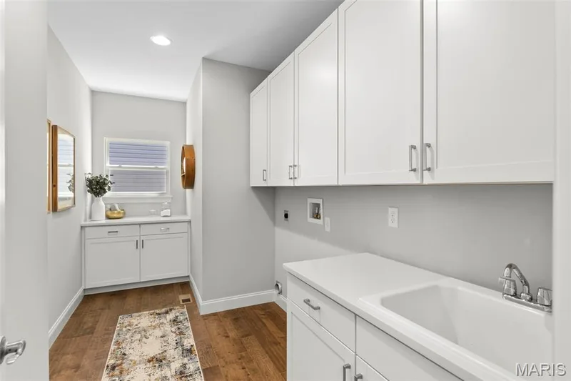 Laundry room featuring dark wood-type flooring, cabinet space, washer hookup, hookup for an electric dryer, and recessed lighting — 2 Pin Oak at Hawk Ridge Estate, Lake St. Louis, MO 63367