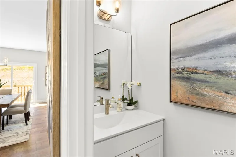 Bathroom with vanity, wood finished floors, and a chandelier — 2 Pin Oak at Hawk Ridge Estate, Lake St. Louis, MO 63367