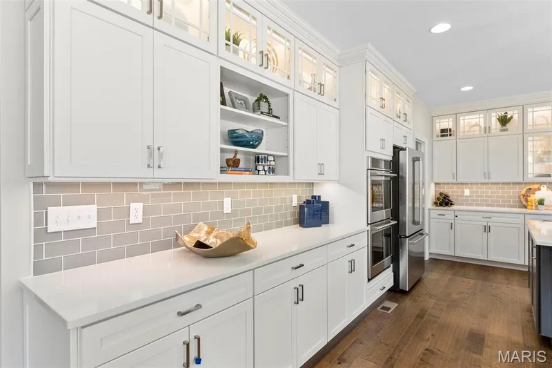 Kitchen featuring glass insert cabinets, open shelves, white cabinets, backsplash, and recessed lighting — 2 Pin Oak at Hawk Ridge Estate, Lake St. Louis, MO 63367