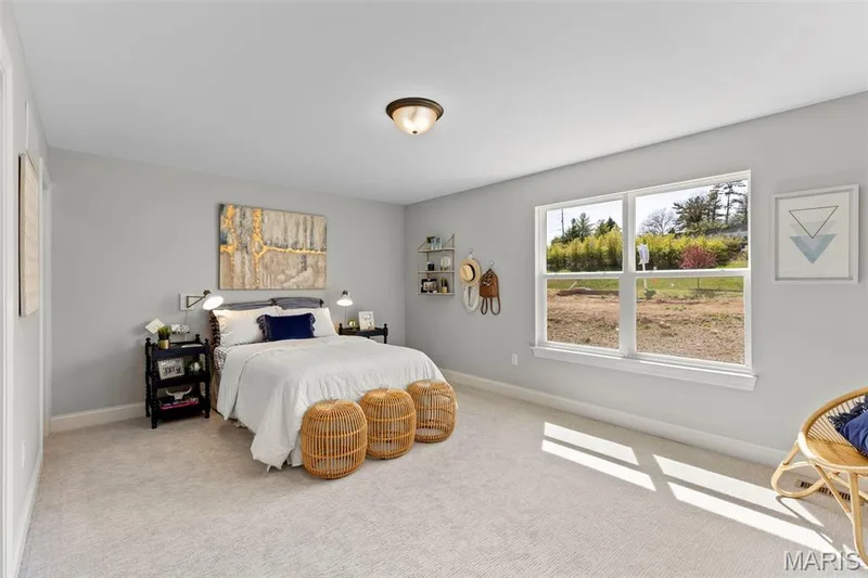 Bedroom with carpet flooring and baseboards — 2 Pin Oak at Hawk Ridge Estate, Lake St. Louis, MO 63367