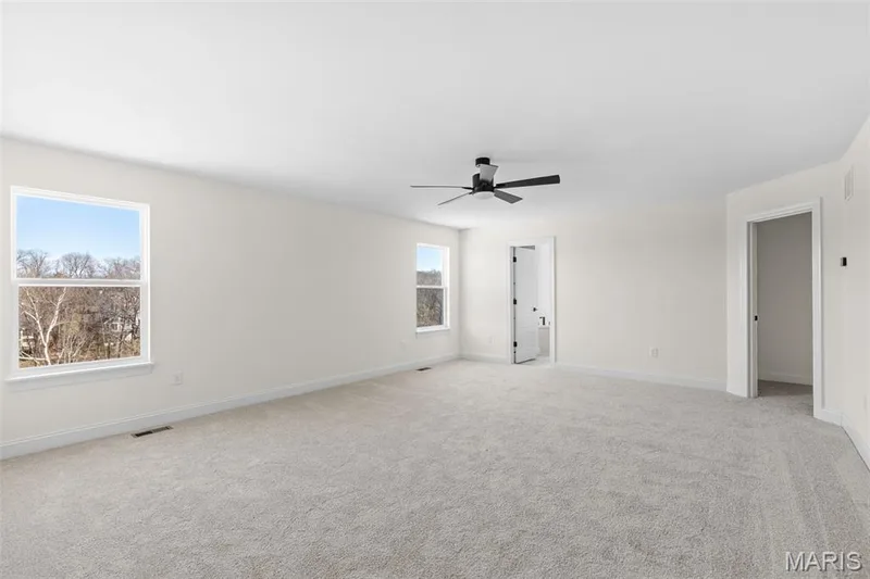 Unfurnished bedroom with light colored carpet and a ceiling fan — 2 Sequoia at Hawk Ridge Estate, Lake St. Louis, MO 63367