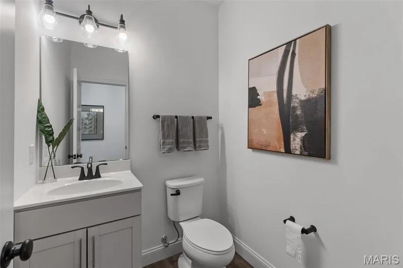Bathroom with vanity and dark wood finished floors — 2 Nottingham at Hawk Ridge, Lake St. Louis, MO 63367