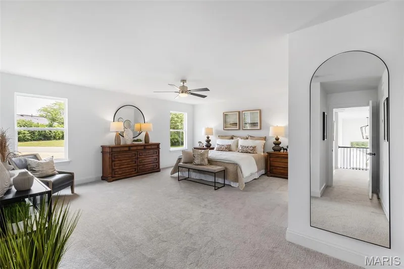 Bedroom with light colored carpet and a ceiling fan — 2 Nottingham at Hawk Ridge, Lake St. Louis, MO 63367