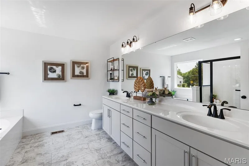 Bathroom with a garden tub, double vanity, and a stall shower — 2 Nottingham at Hawk Ridge, Lake St. Louis, MO 63367