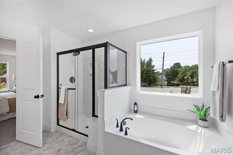 Bathroom with ensuite bathroom, a shower stall, healthy amount of natural light, a garden tub, and recessed lighting — 2 Nottingham at Hawk Ridge, Lake St. Louis, MO 63367