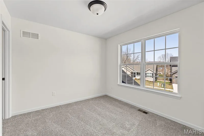 Carpeted empty room with baseboards — 563 Edison Way, Wentzville, MO 63385
