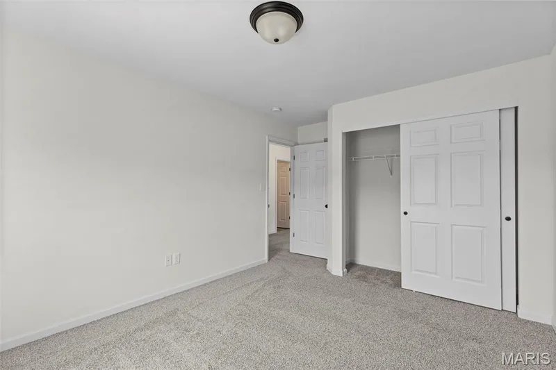 Unfurnished bedroom featuring carpet flooring and a closet — 563 Edison Way, Wentzville, MO 63385