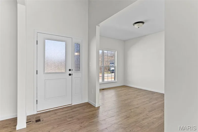 Entrance foyer with light wood-style floors and baseboards — 563 Edison Way, Wentzville, MO 63385