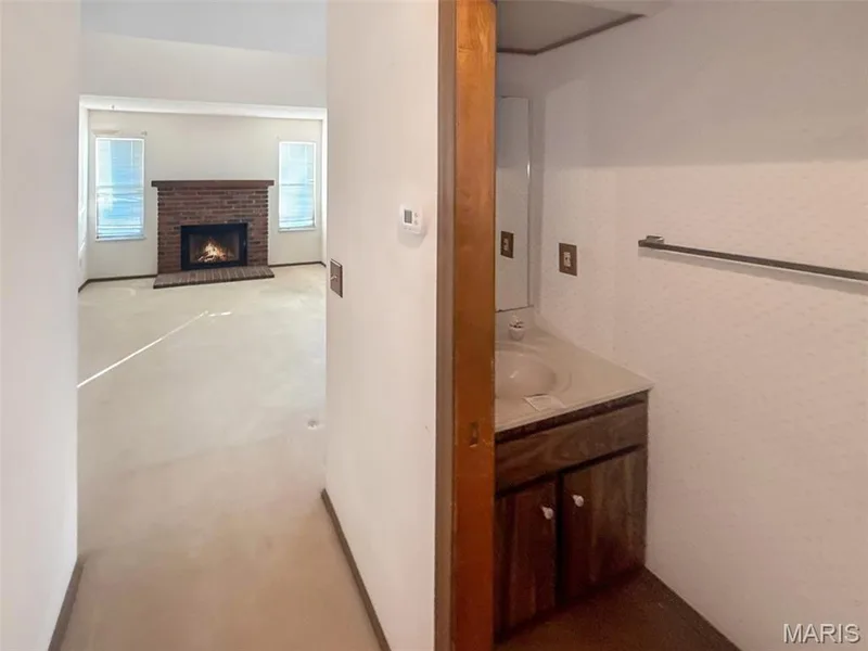 Bathroom with vanity and a fireplace — 312 Crown Colony Court #F, St Peters, MO 63376