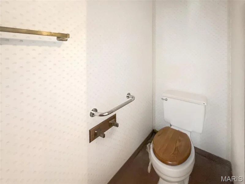 Bathroom featuring toilet and wallpapered walls — 312 Crown Colony Court #F, St Peters, MO 63376