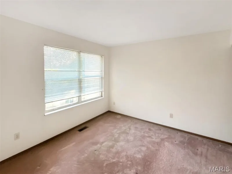 Carpeted empty room featuring baseboards — 312 Crown Colony Court #F, St Peters, MO 63376
