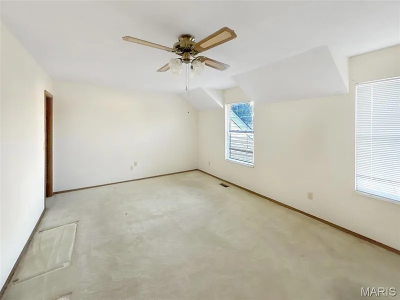 Additional living space featuring a ceiling fan and carpet flooring — 312 Crown Colony Court #F, St Peters, MO 63376