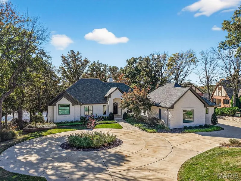 Circle drive with arched entryway and professional landscape — 22 Holloway Drive, Lake St. Louis, MO 63367
