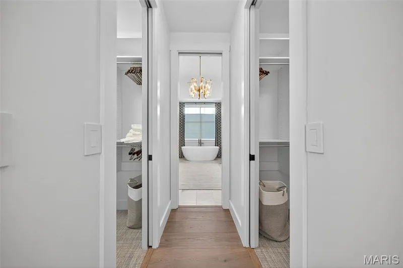 Master bath with his and her walk in closets with built in organizers — 22 Holloway Drive, Lake St. Louis, MO 63367