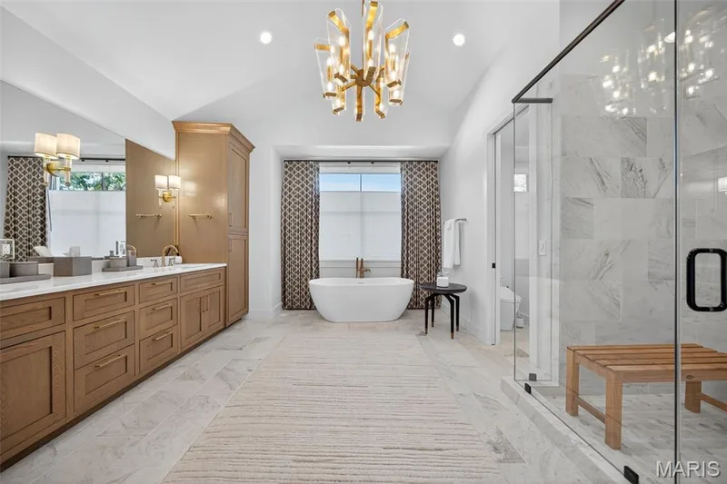 Spa like master bathroom with marble counter top and vaulted ceiling. — 22 Holloway Drive, Lake St. Louis, MO 63367