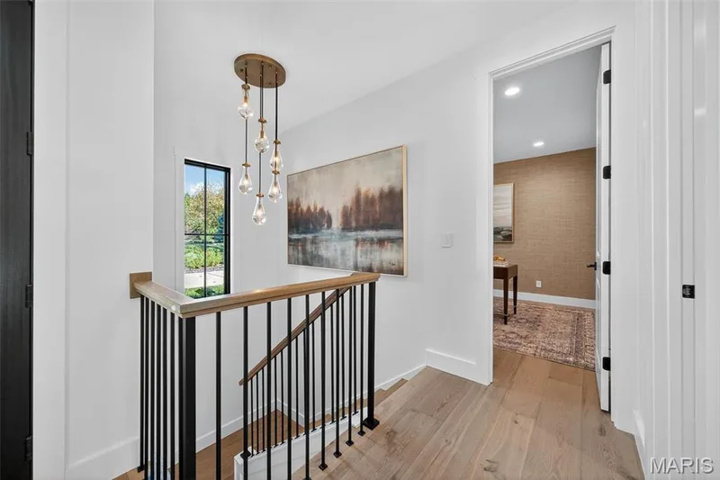 Staircase leading to finished lower level — 22 Holloway Drive, Lake St. Louis, MO 63367