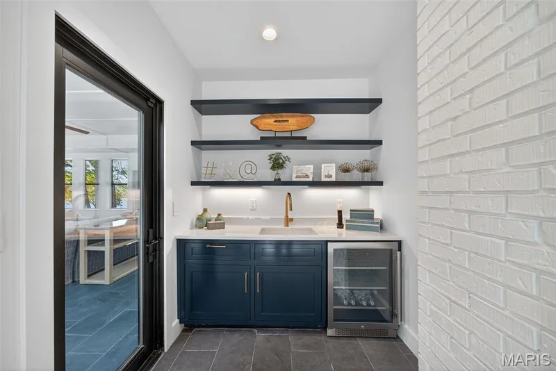 Wet bar with marble counter top.  Door leads into the four seasons room. — 22 Holloway Drive, Lake St. Louis, MO 63367