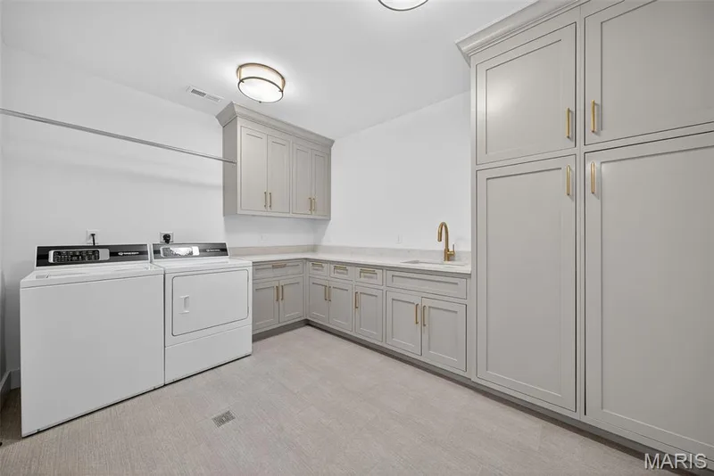 Lower level laundry room with walk in closet and additional storage — 22 Holloway Drive, Lake St. Louis, MO 63367