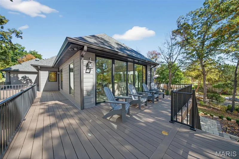 Pella doors off the sun room open to the rear wrap around deck with lake views. — 22 Holloway Drive, Lake St. Louis, MO 63367