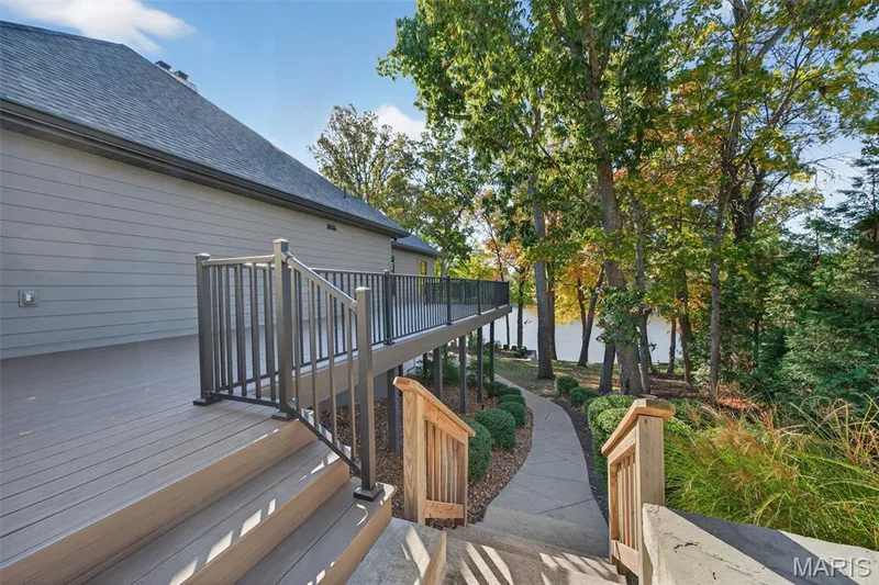 Wrap around deck with walk way to lower level paver patio, four seasons room, lake, and dock. — 22 Holloway Drive, Lake St. Louis, MO 63367