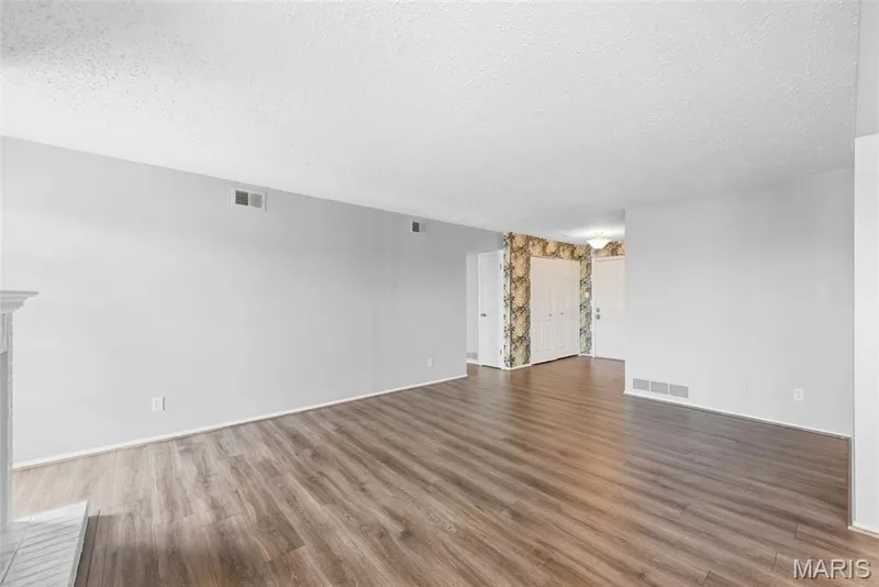 Wood-finish flooring throughout, bright white walls, and a recessed ceiling light — 14443 Bantry Lane #16, Chesterfield, MO 63017
