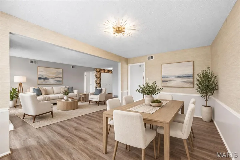 Wood-finish flooring throughout, with a recessed archway separating living areas — 14443 Bantry Lane #16, Chesterfield, MO 63017