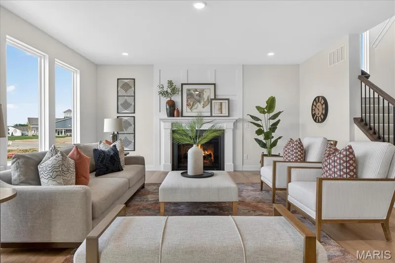 Family room with view of window wall and fireplace — 125 Sterling Drive, Lake St. Louis, MO 63367