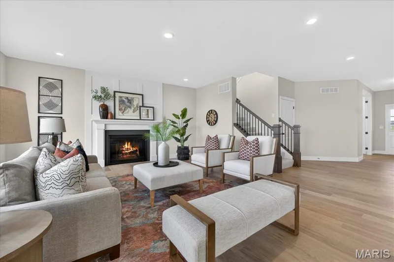 Family room with view of window wall and fireplace — 125 Sterling Drive, Lake St. Louis, MO 63367