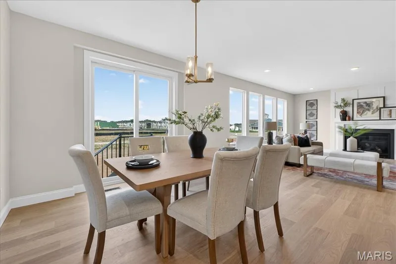 Breakfast area with view of back sliding door and family room — 125 Sterling Drive, Lake St. Louis, MO 63367