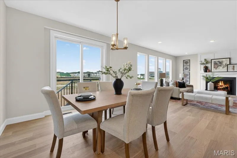 Breakfast area with view of back sliding door and family room — 125 Sterling Drive, Lake St. Louis, MO 63367