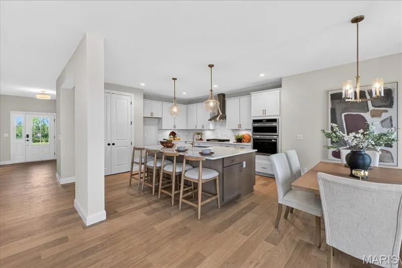 Kitchen with built-in stainless steel gas appliances, custom cabinets and Quartz countertops — 125 Sterling Drive, Lake St. Louis, MO 63367