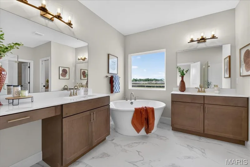 Primary bathroom with separate tub and shower, split vanity, double bowls — 125 Sterling Drive, Lake St. Louis, MO 63367