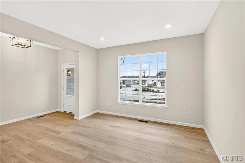 Living room with light wood finished floors and recessed lighting — 210 Randlin Drive, O'Fallon, MO 63367