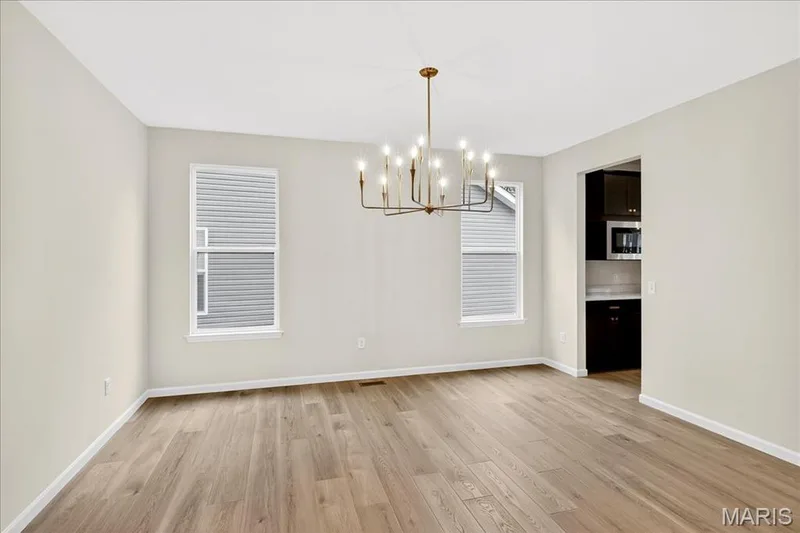 dining area featuring light wood-style floors and a chandelier — 210 Randlin Drive, O'Fallon, MO 63367