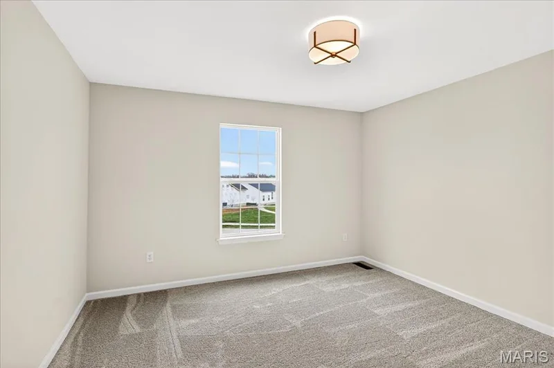 Bedroom featuring carpet flooring and baseboards — 210 Randlin Drive, O'Fallon, MO 63367