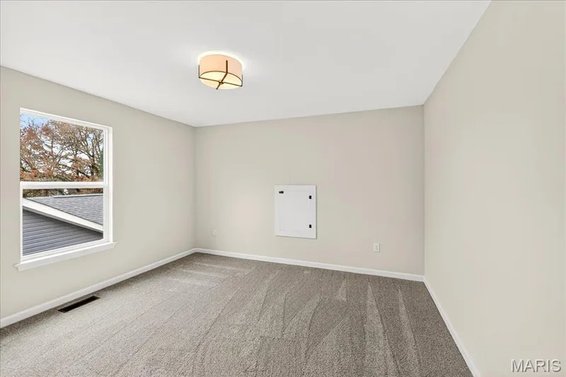 Bedroom featuring carpet and baseboards — 210 Randlin Drive, O'Fallon, MO 63367