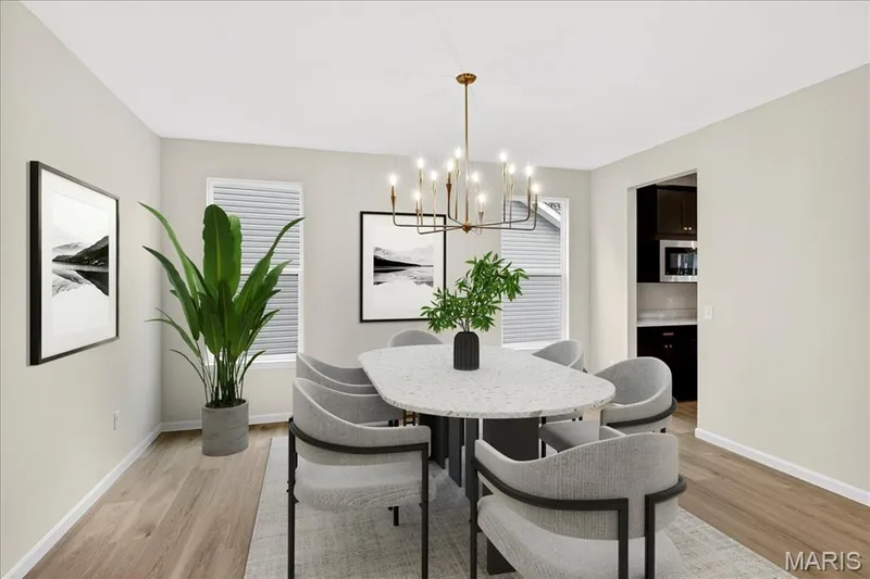 Dining area with a chandelier and light wood-style flooring — 210 Randlin Drive, O'Fallon, MO 63367