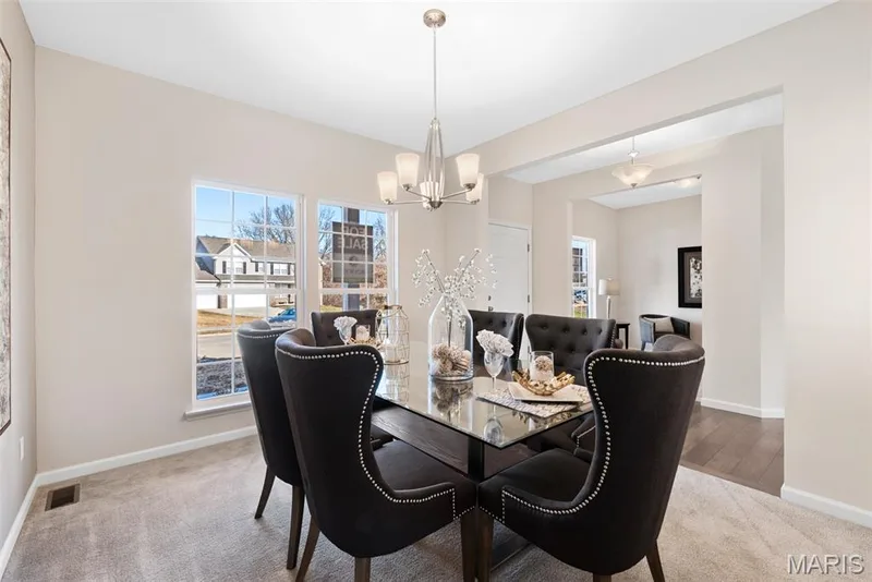 Dining area with light colored carpet and a chandelier — 1 TBB Princeton @ Kreder Farms, St Charles, MO 63304