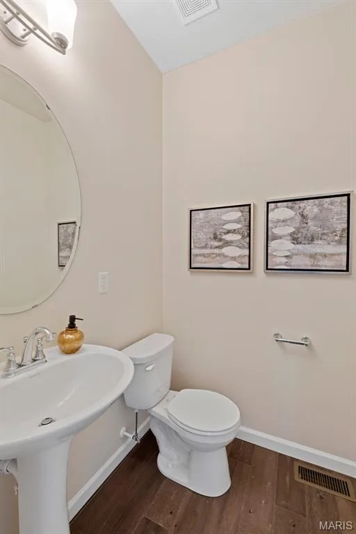 Bathroom with dark wood-style flooring and baseboards — 1 TBB Princeton @ Kreder Farms, St Charles, MO 63304