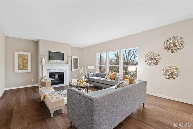 Living room featuring a fireplace and dark wood finished floors — 1 TBB Princeton @ Kreder Farms, St Charles, MO 63304