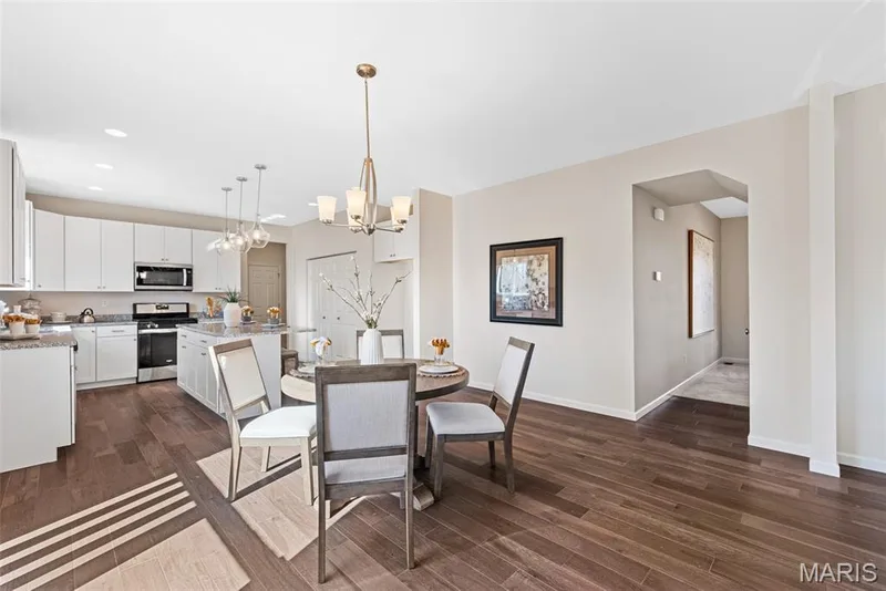 Dining area with dark wood finished floors, a chandelier, and recessed lighting — 1 TBB Princeton @ Kreder Farms, St Charles, MO 63304