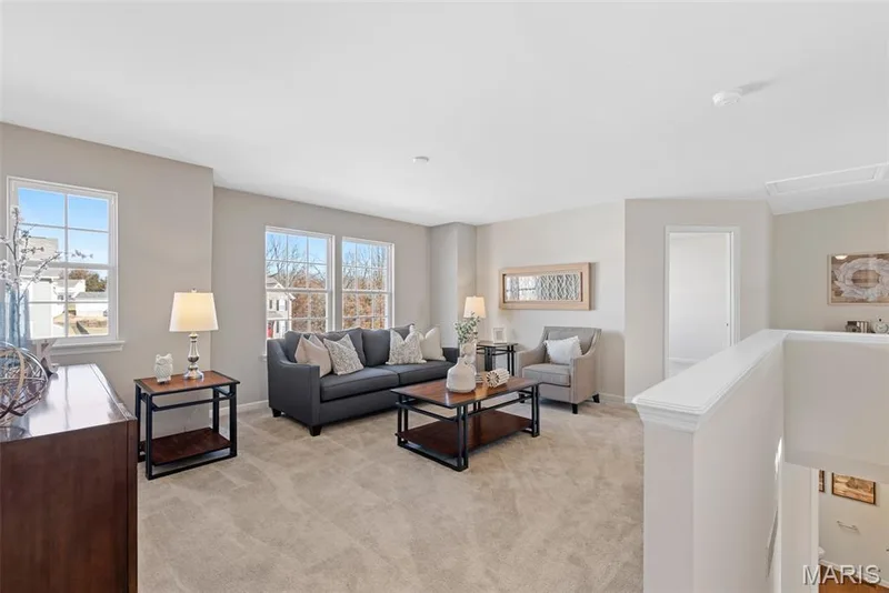 Living area featuring light carpet and baseboards — 1 TBB Princeton @ Kreder Farms, St Charles, MO 63304