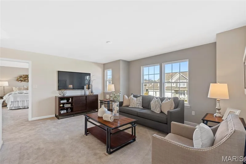 Carpeted living room featuring baseboards — 1 TBB Princeton @ Kreder Farms, St Charles, MO 63304