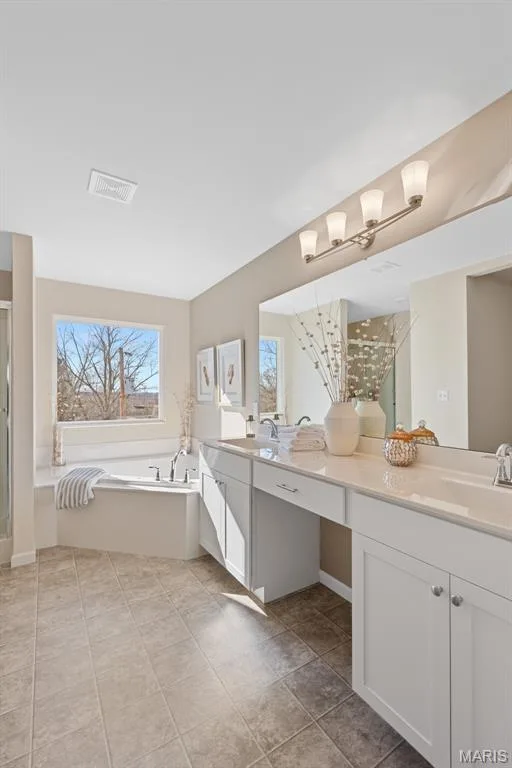Full bathroom featuring a stall shower, double vanity, a garden tub, and light tile patterned floors — 1 TBB Princeton @ Kreder Farms, St Charles, MO 63304