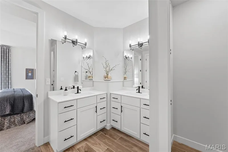 Ensuite bathroom with wood tiled floors and two vanities — 1 TBB Canterbury @ Kreder Farms, St Charles, MO 63304