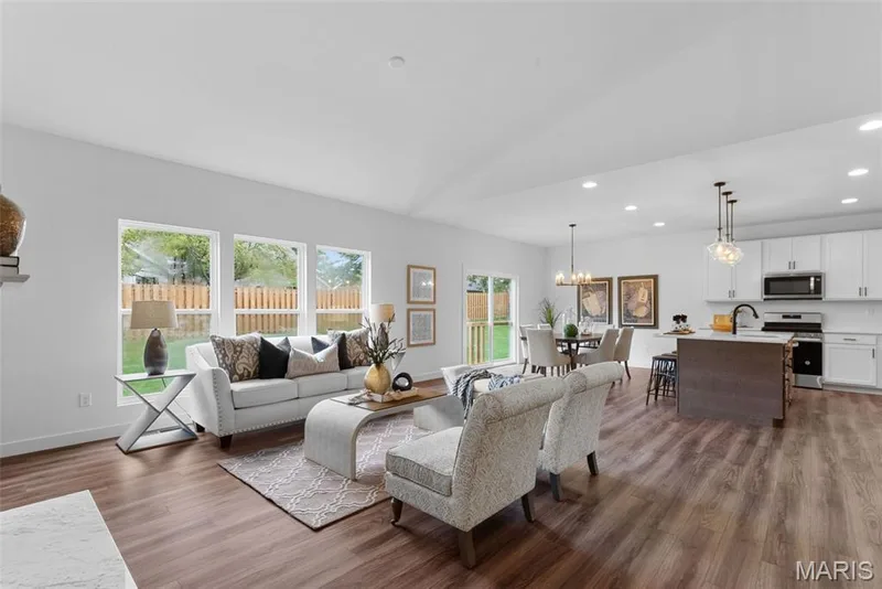 Living room with recessed lighting, lofted ceiling, dark wood-style floors, and a chandelier — 1 TBB Rochester @ Kreder Farms, St Charles, MO 63304
