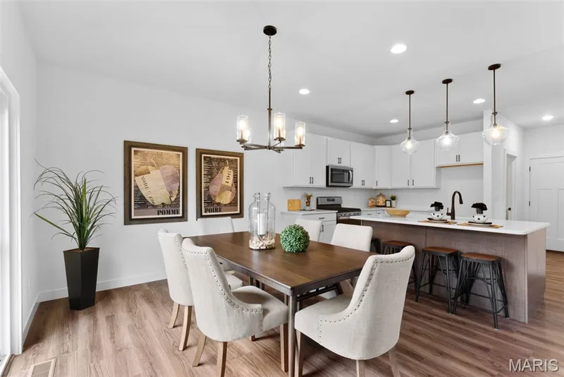 Dining room with a chandelier, light wood-style floors, and recessed lighting — 1 TBB Rochester @ Kreder Farms, St Charles, MO 63304