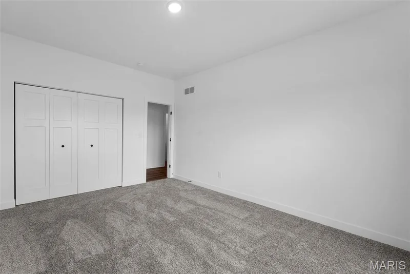 Unfurnished bedroom featuring a closet and carpet — 1 TBB Rochester @ Kreder Farms, St Charles, MO 63304